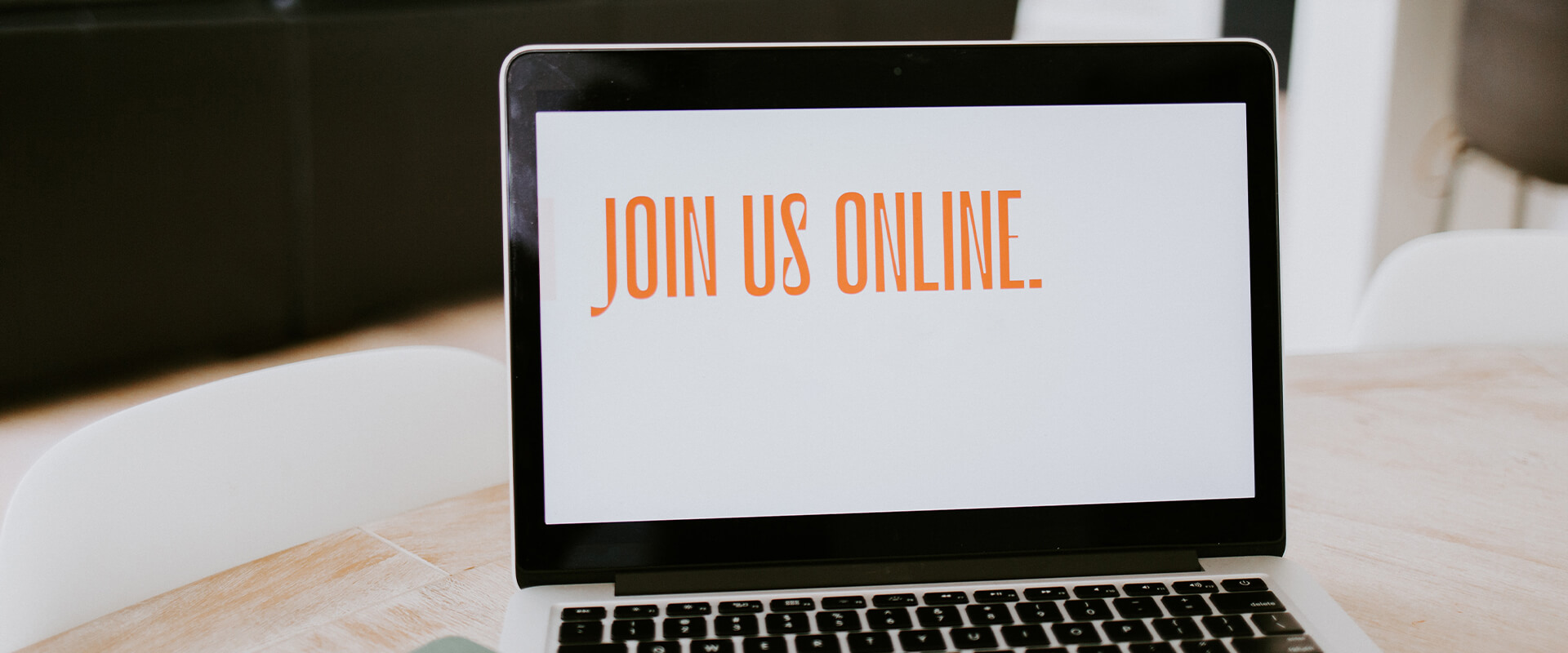 Laptop with the words 'Join us online' on the screen