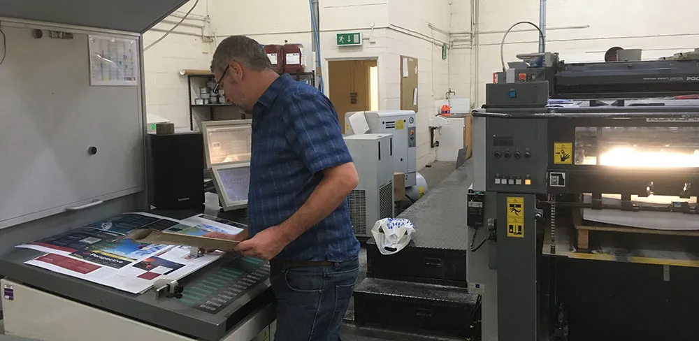 Man working with industrial printers