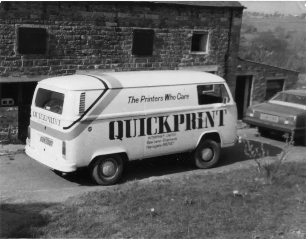 Old van with 'Quick Print' graphic on the side