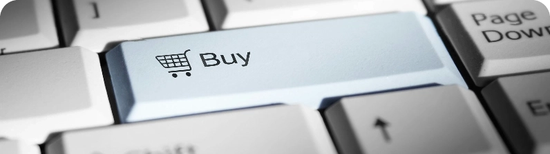 Blue 'Buy' key with a shopping cart icon on a keyboard, symbolizing online purchasing.